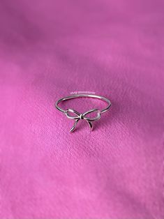 A stunning coquette style ring featuring a sweet ribbon bow tie. - Water resistant - 925 sterling silver - Will not rust or tarnish - Select desired size at checkout Dainty Rings Minimalist Jewelry Silver, Trendy Rings Silver, Girly Jewelry Silver, Silver Bow Ring, Coquette Rings, Cute Rings Silver, Rings Coquette, Coquette Ring