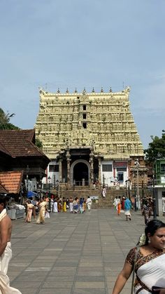 people are walking around in front of a temple