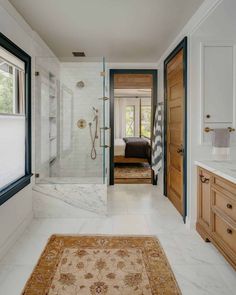 a large bathroom with marble floors and walls, along with a walk - in shower