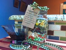 a jar filled with lots of candy sitting on top of a table