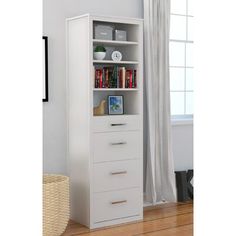 a tall white bookcase with three drawers