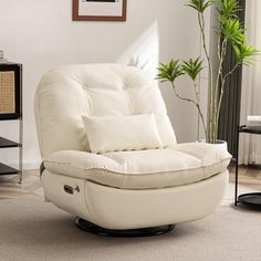 a living room with a white chair and a potted plant