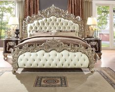 an ornate bed with white upholstered headboard and foot board in a bedroom