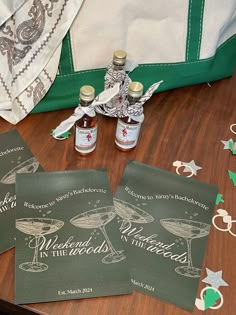 three bottles of alcohol sitting on top of a wooden table next to christmas decorations and other items