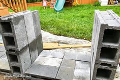 cinder blocks are stacked on top of each other to form a play area in the back yard