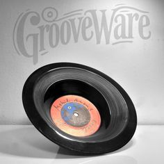 an old record with the word groveware on it sitting in front of a white wall