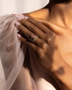 a woman's hand holding onto her wedding ring