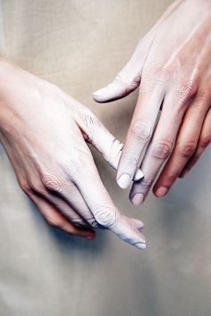 black and white photograph of two hands touching each other