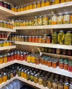 many jars filled with different types of food on wooden shelvings in a store