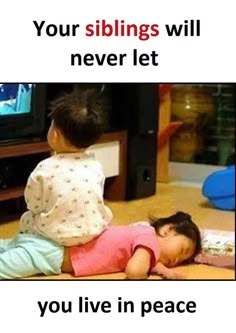 two children are sitting on the floor and one is playing with a television screen in front of them