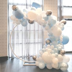 a bunch of balloons that are in the shape of a circle on a table next to a window