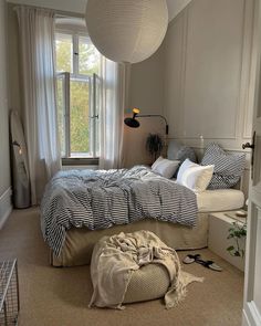 a bedroom with a large bed and a round bean bag chair in the corner next to it