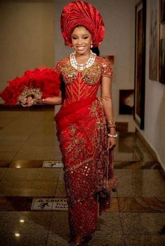 a woman in a red dress and headdress