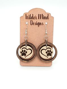 Dog Paw Heart Earrings They are made from with Maple and Walnut Plywood, made to be stronger and more durable. These earrings are laser cut, laser engraved. They are super lightweight making them easy to wear all day!  Ear wires are made from surgical stainless steel. Since these earrings are made from wood, I highly recommend taking them off for any water related activities such as swimming or showering. They come packed on an earring card holder in an organza drawstring jewelry bag perfect for Earring Card Holder, Laser Jewelry, Cricut Earrings, Laser Crafts, Dog Sayings, Wood Burning Pen, Engraving Projects, Paw Print Earrings, Walnut Plywood