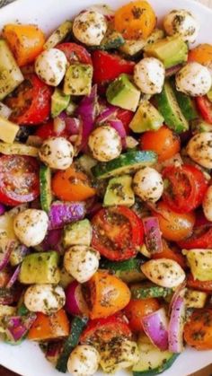 a mixture of vegetables including tomatoes, zucchini, and other veggies