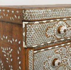 an ornately decorated chest of drawers on display