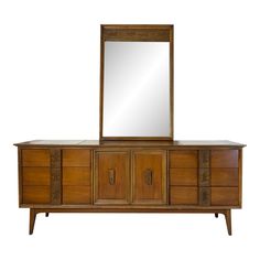 a large wooden dresser with a mirror on it's top and two drawers below