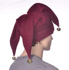 Three pointed jester hat made in burgundy fleece. This is a joker style fools cap, one point in the front with two points to the rear side. Each of the point are tipped of with a silver jingle bell. Red double thick headband. One size fits most adults 22-24 inch heads. Christmas Jester Gifts, Jester Hat Sewing Pattern, Jester Hat Pattern, Jester Outfits, Jester Halloween Costume, Jester Aesthetic, Jester Halloween, Joker Hat, Jester Outfit