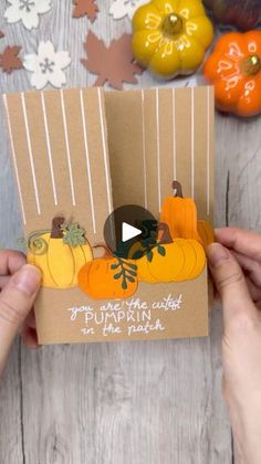 someone holding up a card with pumpkins on it