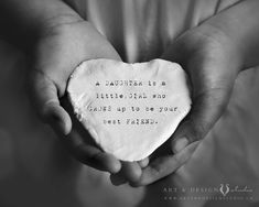 two hands holding a heart shaped stone with the words, happiness is a little child who goes up to be your best friend