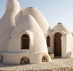 an unusual house made out of white clay