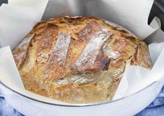 a loaf of bread sitting in a pan on top of a blue and white towel