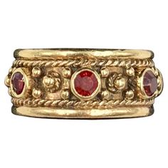 Ornate Renaissance style 14K yellow gold garnet set band ring Late 19th Century Marks: Marker's mark A within a shield, 14K Technique: Twisted gold wire work, granulation, cullet set gemstones Size: 5.75 US Very Good Condition Very fine quality, intricate design and excellent workmanship, Hand crafted by an expert jeweler, this beautiful band is fit for a Renaissance princess or prince. A well rendered maker's mark on the interior of the letter A within a shield shaped crest. The garnets, rich vibrant red in color, faceted, cullet set. An ancient gemstone, garnet has been revered by the Egyptians, Greeks, Romans, Anglo-Saxons, Medieval Crusaders, Hunza warriors, Kings and Queens. It has historically been associated with the heart, inner fire, love, friendship and vitality. Amulets using th Red And Gold Ring, Medieval Rings, Historical Jewellery, Garnet Jewelry, Ancient Jewelry, Gold Band Ring, Gold Wire, Gold Bands, Band Ring