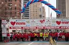 a group of people standing in front of a marathon finish line