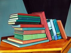 a stack of books sitting on top of a wooden table