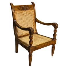 a wooden chair with wicker seat and armrests on an isolated white background