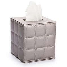 a tissue dispenser sitting on top of a gray box with a white tissue in it