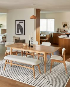 a dining room table with chairs and a bench