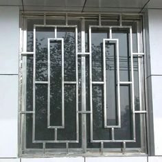 an image of a window that is on the side of a building with metal bars