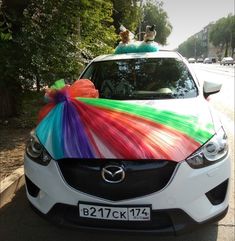 a car decorated with colorful ribbons and bows