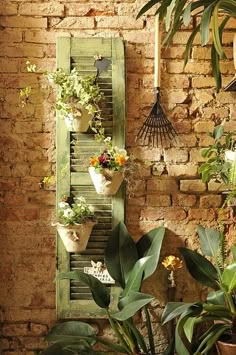 the interior of a brick building with potted plants and hanging birdhouses on the wall