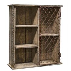 an old wooden cabinet with two shelves on one side and a chain link fence on the other