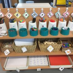 a wooden shelf filled with lots of different types of pens and pencils on top of it