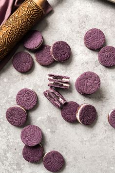 purple cookies are arranged on a table next to a knife