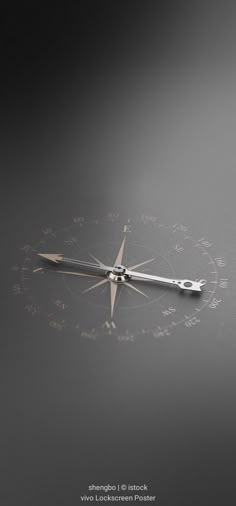 a compass is shown on a dark surface with writing all over the place and it appears to be upside down