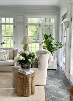 a living room filled with furniture and lots of windows