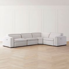 a white couch sitting on top of a hard wood floor