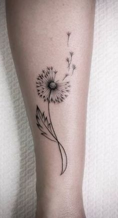 a dandelion tattoo on the ankle