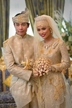 a man and woman standing next to each other in formal wear, holding bouquets