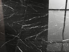 a black and white photo of marble flooring