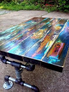 an old table is painted with colorful paint