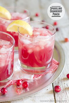 two glasses filled with cranberry lemonade on top of a silver platter