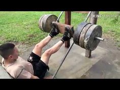 a man is doing a bench press with two barbells