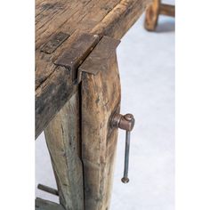 an old wooden bench with two nails on it