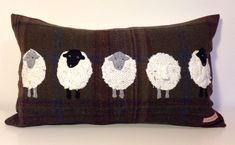 a brown pillow with four sheep on it