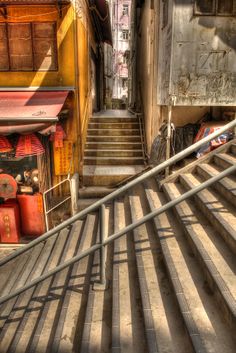 an alleyway with stairs leading up and down